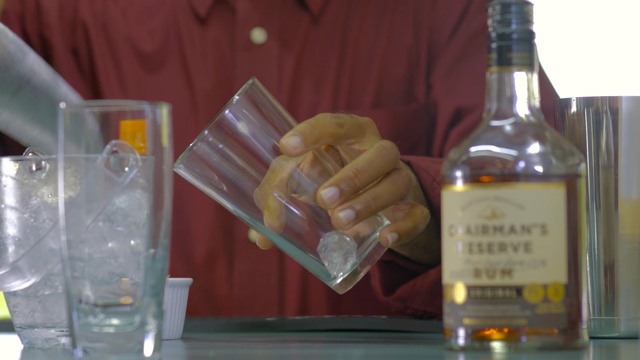 Video Reference: liqueur, distilled beverage, drink, alcoholic beverage, bottle, glass bottle, alcohol, whisky, glass, wine, Person