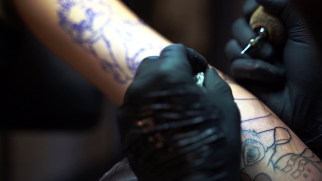 Video Reference: Tattoo, Arm, Skin, Wrist, Hand, Tattoo artist, Joint, Finger, Flesh, Muscle