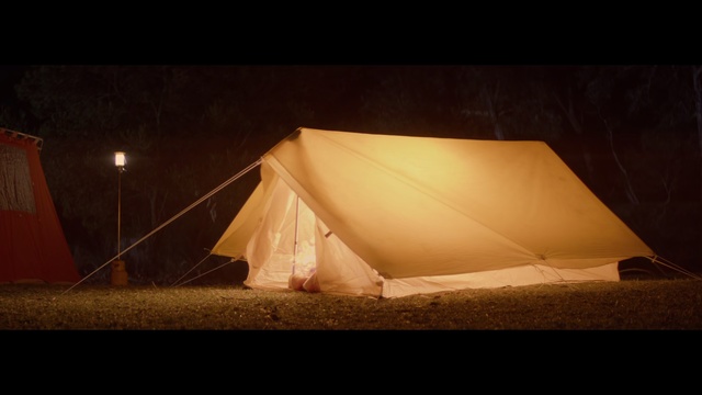 Video Reference: Tent, Light, Lighting, Night, Tints and shades, Landscape, Shade, Camping, Table, Sitting, Dark, Lit, Covered, Snow, Umbrella, Man, Large, Water, Boat, White, Holding, Room, Board, Standing, Tarpaulin, Outdoor object
