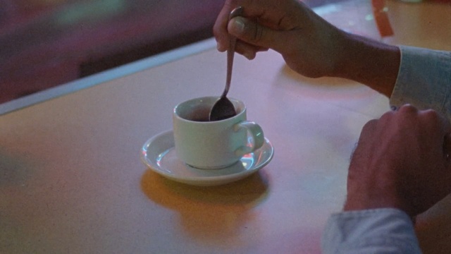 Video Reference: Cup, Cup, Serveware, Coffee, Turkish coffee, Coffee cup, Hand, Table, Drink, Tableware, Person
