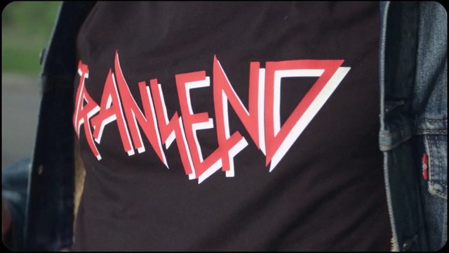 Video Reference: red, t shirt, outerwear, font, flag, logo, brand, product, Person