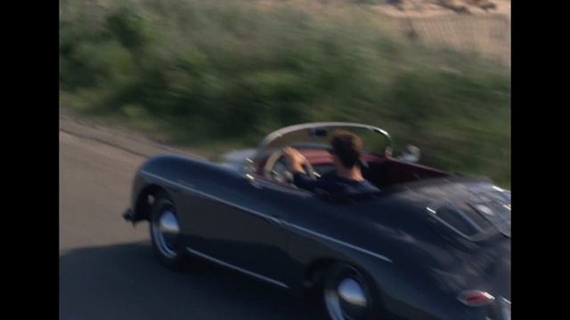Video Reference: Land vehicle, Vehicle, Car, Classic car, Coupé, Convertible, Automotive design, Mid-size car, Sports car, Sedan, Outdoor, Road, Riding, Street, Small, Photo, Mirror, Driving, Man, Side, View, Head, Dog, Woman, Red, Young, Holding, Traffic, White, Motorcycle, Truck, Wheel, Person