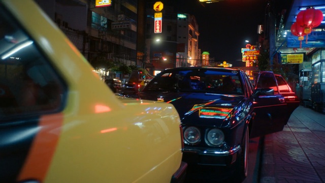 Video Reference: car, motor vehicle, vehicle, night, automotive design, taxi, city car, metropolitan area, city, traffic, Person