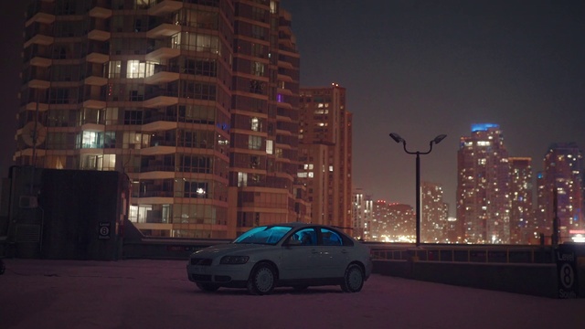 Video Reference: Urban area, Vehicle, Car, Downtown, Metropolitan area, City, Night, Sky, Atmospheric phenomenon, Human settlement