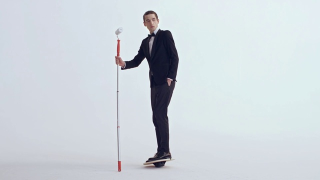 Video Reference: Standing, Suit, Arm, Formal wear, Recreation, Balance, Tuxedo, Businessperson, Shoe