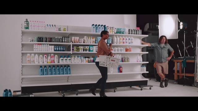 Video Reference: Product, Beauty, Snapshot, Retail, Service, Building, Pharmacy, Advertising, Shelf, Furniture, Indoor, Person, Man, Standing, Front, Woman, Table, Holding, Young, People, Room, Board, Refrigerator, Doing, Dog, Video, White, Kitchen, Playing, Group, Text, Bookcase