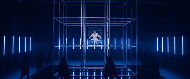 Video Reference: blue, stage, structure, light, darkness, architecture, theatrical scenery, scene, symmetry, computer wallpaper, Person