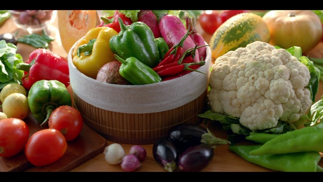 Video Reference: Natural foods, Food, Cauliflower, Vegetable, Cruciferous vegetables, Ingredient, Vegan nutrition, Food group, Local food, Whole food, Table, Indoor, Fruit, Plate, Bowl, Filled, Fresh, Wooden, Sitting, Small, Counter, Different, Little, Apple, Holding, White, Tomato, Diet food, Produce, Bell pepper, Superfood, Zucchini, Cucumber, Bell peppers and chili peppers, Vegetarian food, Capsicum, Pimiento, Bush tomato, Cherry tomatoes, Watermelon, Cabbage, Plum tomato, Cucumis, Leaf vegetable, Carrot, Nutraceutical, Habanero chili, Chili pepper, Legume, Greengrocer, Eggplant, Summer squash, Radish, Red bell pepper, Salad, Serrano pepper, Staple food, Italian sweet pepper, Banana, Mango, Peperoncini, Yellow pepper, Tabasco pepper, Onion, Cayenne pepper, Malagueta pepper, Birds eye chili, Paprika, Containing, Arranged