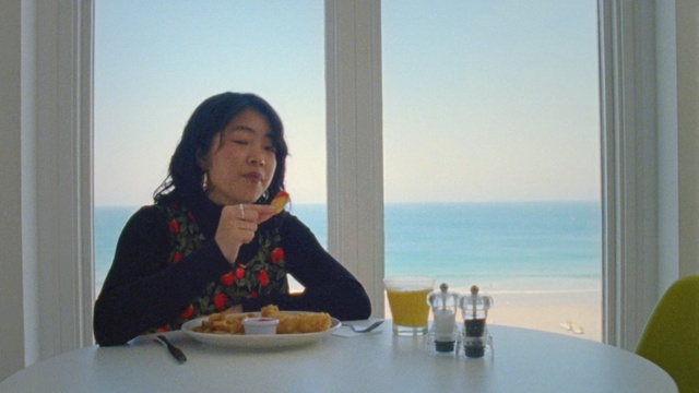 Video Reference: woman, asian, breakfast, ocean, food, window, sky, sun , Person