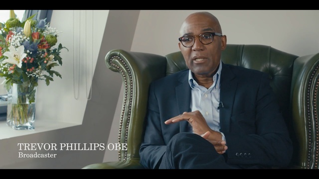 Video Reference: sitting, public speaking, suit, speech, gentleman, official, speaker, conversation, businessperson, human behavior, Person