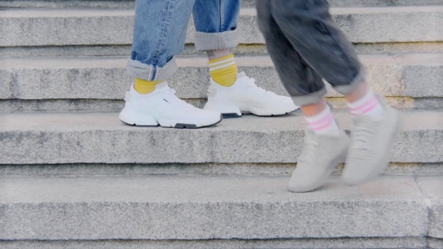 Video Reference: White, Footwear, Jeans, Shoe, Denim, Leg, Street fashion, Ankle, Boot, Human leg, Outdoor, Person, Building, Cellphone, Woman, Sidewalk, Young, Holding, Standing, Girl, Phone, Cat, Talking, Sitting, Using, Face, Boy, Little, Riding, Wearing, Walking, Street, Grey, Man, Statue, Board, Bird, Water, City, Red, Doing, Hat, Blue, Perched, Umbrella, Trick, Horse, Trousers, Clothing, Feet, Step, Sneaker, Cement, Stair