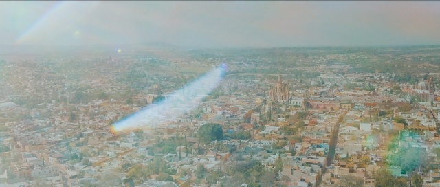 Video Reference: aerial photography, sky, bird's eye view, atmosphere, daytime, city, haze, meteorological phenomenon