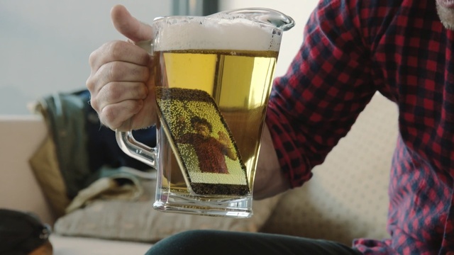 Video Reference: drink, alcoholic beverage, beer, alcohol, bottle, liqueur, pint us, glass, drinkware, Person