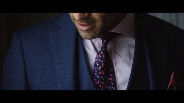 Video Reference: necktie, suit, fashion accessory, gentleman, formal wear, outerwear, blazer, facial hair, plaid, tuxedo