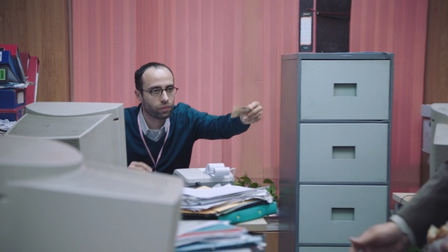 Video Reference: file, office furniture, furniture, man, laptop, computer, male, printer, office, person, business, home, people, adult