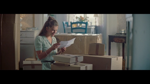 Video Reference: room, snapshot, sitting, girl, furniture, screenshot, scene, table, conversation, reading
