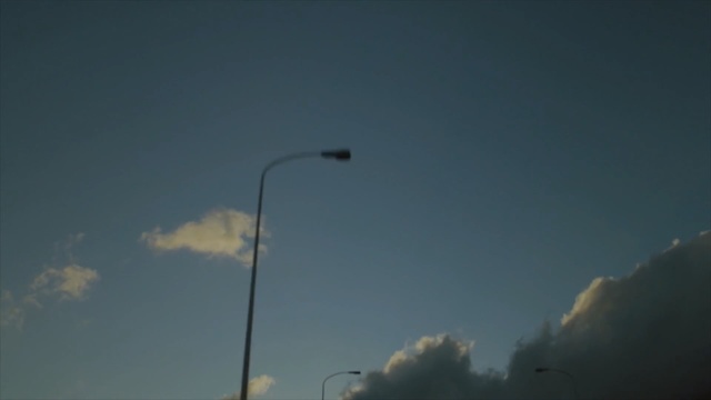 Video Reference: sky, cloud, atmosphere, daytime, street light, light, light fixture, cumulus, lighting, meteorological phenomenon