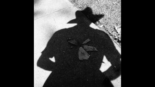 Video Reference: Photograph, Black, Black-and-white, Monochrome photography, Standing, Shadow, Snapshot, Gentleman, Outerwear, Photography