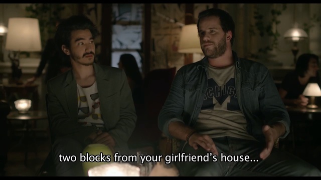 Video Reference: Photo caption, Movie, Human, Fun, Screenshot, Photography, Adaptation, Darkness, Scene, Conversation, Person, Indoor, Table, Man, Sitting, People, Woman, Holding, Food, Group, Standing, Kitchen, Young, Restaurant, Pizza, White, Plate, Human face, Clothing, Text