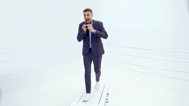 Video Reference: Standing, Product, Businessperson, Suit, Photography, White-collar worker, Outerwear, Blazer, Jacket, Shoe