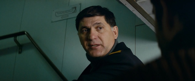 Video Reference: Face, Chin, Forehead, Cheek, Fun, Facial hair, Jaw, Smile, Person, Indoor, Man, Looking, Holding, Front, Camera, Mirror, Black, Computer, Laptop, Hand, Table, Young, Sitting, Standing, Smiling, Shirt, Room, White, Video, Kitchen, Wall, Human face, Portrait, Clothing