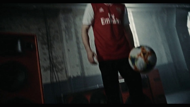 Video Reference: Standing, Red, Shoulder, Sportswear, T-shirt, Snapshot, Ball, Arm, Joint, Muscle, Person, Indoor, Man, Front, Young, Shirt, Using, Holding, Wearing, Table, White, Board, Kitchen, Clothing, Sports uniform, Human face