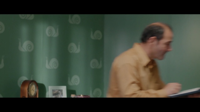 Video Reference: green, man, public speaking, sitting, speech, male, conversation, screenshot, lecture, human, Person