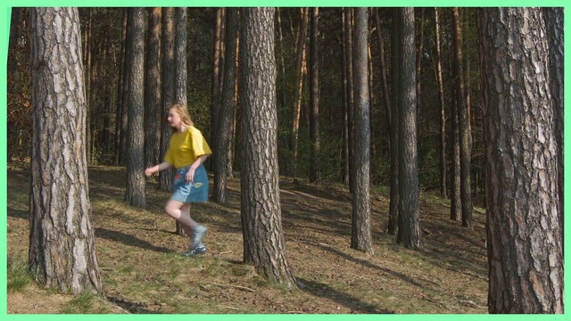 Video Reference: People in nature, Tree, Woodland, Forest, Natural environment, Biome, Woody plant, Recreation, Northern hardwood forest, Plant, Outdoor, Grass, Man, Wood, Frisbee, Throwing, Green, Park, Playing, Wooded, Field, Ball, Standing, Preparing, Young, Area, Yellow, Catch, Wearing, Holding, Shirt, Flying, Grassy, Air, Blue, Person, Text, Footwear, Clothing