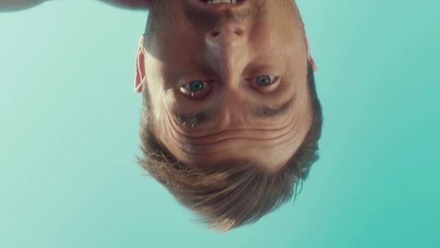 Video Reference: Face, Hair, Nose, Head, Chin, Skin, Forehead, Eyebrow, Cheek, Eye, Person, Man, Indoor, Looking, Wearing, Swimming, Camera, Front, Smiling, Photo, Glasses, Shirt, Blue, Sitting, White, Posing, Close, Large, Standing, Holding, Water, Hat, Eyes, Human face, Water sport, Portrait, Staring, Spectacles, Goggles