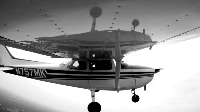 Video Reference: airplane, light aircraft, aircraft, aviation, black and white, air travel, flight, aerospace engineering, propeller driven aircraft, monochrome photography, Person
