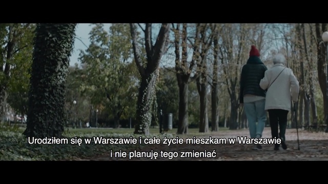 Video Reference: Nature, Tree, Natural environment, Woodland, Photo caption, Woody plant, Forest, Photography, Adaptation, Organism, Outdoor, Person, Woman, Man, Standing, Walking, Holding, Snow, Game, Park, Young, People, Wearing, Riding, Black, Street, Board, Umbrella, Sign, Skiing, Doing, Playing, Group, White, Text, Screenshot
