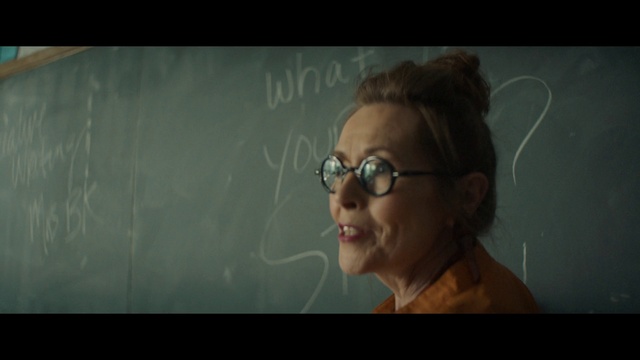 Video Reference: Eyewear, Portrait, Head, Glasses, Lady, Nose, Vision care, Human, Forehead, Photography, Person, Holding, Looking, Man, Woman, Sitting, Hand, Front, Orange, Standing, Screen, Young, Glass, Red, Room, White, Shirt, Human face, Smile, Text