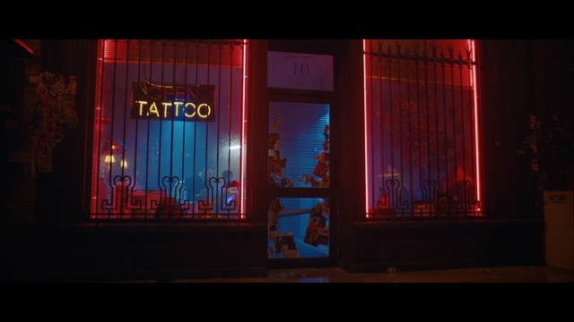 Video Reference: Red, Light, Lighting, Line, Stage, Textile, Darkness, Magenta, Room, Curtain, Building, Dark, Lit, Night, Sitting, Sign, Front, Screen, Street, Fire, Large, City, Television, People, Standing, Man, Restaurant, Brick, Traffic, White