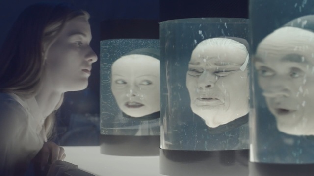 Video Reference: Face, Head, Blue, Forehead, Art, Stone carving, Sculpture, Collection, Person, Woman, Indoor, Photo, Looking, Glass, Lady, Sitting, Holding, Female, Girl, Table, Front, Standing, Food, Young, White, Water, Mirror, People, Mug, Man, Human face, Statue, Beautiful