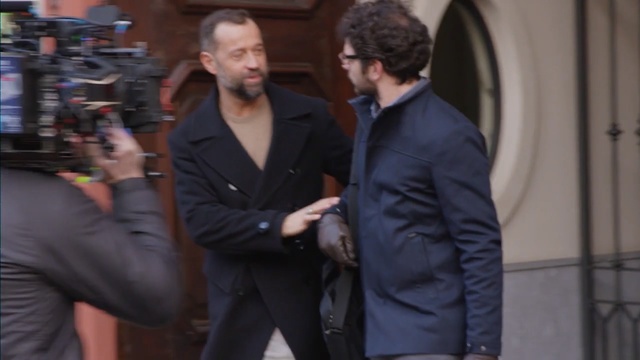 Video Reference: suit, fashion, outerwear, event, gentleman, product, formal wear, flooring, tuxedo, white collar worker, Person