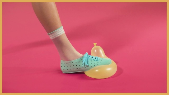 Video Reference: Footwear, Shoe, Pink, Ankle, Leg, Joint, Human leg, Foot, Finger, Slipper, Person, Yellow, Holding, Woman, Sitting, Racket, Hand, Table, Young, Player, Black, Ball, Playing, Remote, Standing, Female, Girl, Game, White, Red, Blue, Video, Court, Text