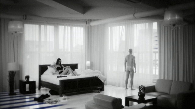 Video Reference: black, photograph, room, black and white, interior design, photography, monochrome photography, furniture, window covering, window, Person