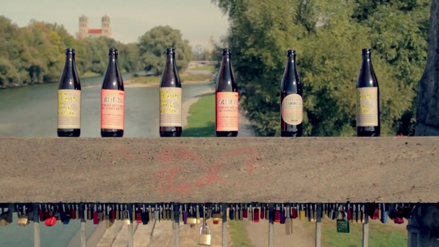 Video Reference: bottle, glass bottle, vehicle, grass, wine bottle, wine, drinkware, Person