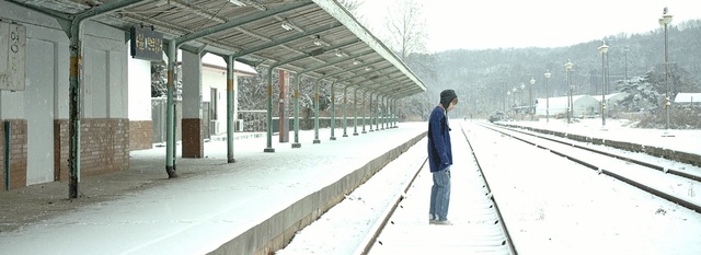 Video Reference: track, snow, transport, winter, train station, residential area, freezing, tree, vehicle, ice, Person