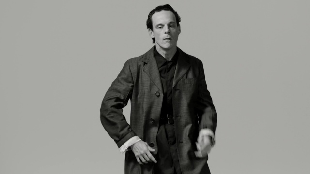 Video Reference: suit, photograph, man, black and white, standing, gentleman, formal wear, male, monochrome photography, outerwear, Person