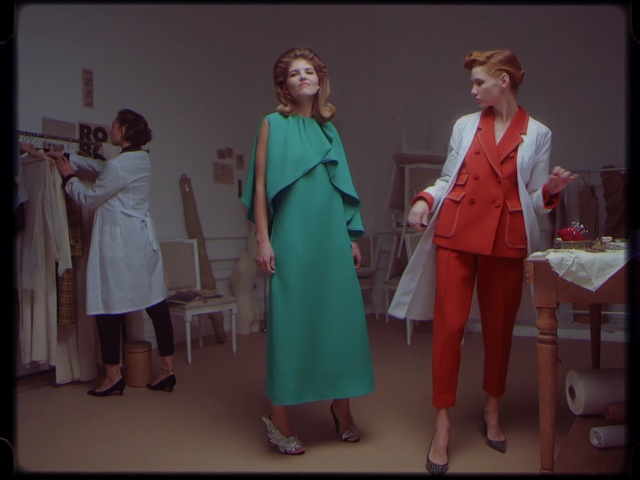 Video Reference: dress, fashion, standing, outerwear, girl, formal wear, fashion design, costume, Person