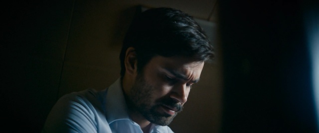 Video Reference: Hair, Face, Head, Facial hair, Nose, Chin, Forehead, Beard, Male, Human, Person, Man, Indoor, Looking, Laptop, Front, Sitting, Computer, Standing, Shirt, Holding, Table, Young, Using, Dark, Screen, Glasses, Food, Room, White, Human face, Screenshot, Portrait, Clothing, Eyes, Human beard