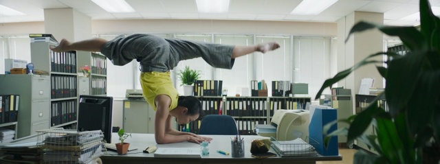 Video Reference: woman, office, books, crazy, dance, leg, window, Person