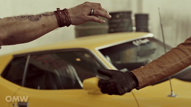Video Reference: Yellow, Hand, Vehicle, Arm, Car, Vehicle door, Automotive exterior, Automotive design, Finger, Gesture