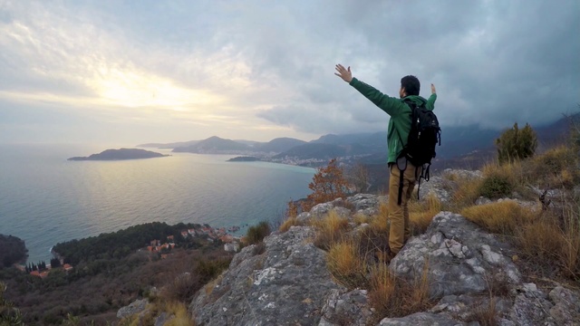 Video Reference: Ridge, Mountain, Fell, Hill, Adventure, Recreation, Terrain, Landscape, Highland, Cliff, Person, Outdoor, Man, Nature, Rock, Jumping, Air, Riding, Snow, Grass, Water, Green, Doing, Board, Yellow, Rocky, Flying, Young, Trick, Covered, Standing, Skiing, Field, Sky, Hiking, Lake, Cloud