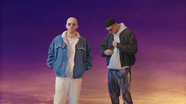 Video Reference: Performance, Fun, Drama, Performing arts, Event, Scene, Landscape, Heater, Person, Outdoor, Man, Standing, People, Group, Water, Street, Wearing, Holding, Walking, Riding, City, Field, Board, Slope, Fire, Airplane, Clothing, Jeans, Trousers, Shirt