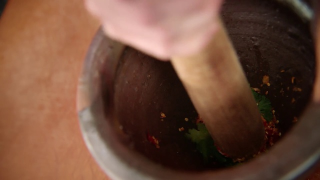 Video Reference: Food, Hand, Cuisine, Dish, Ingredient, Hoisin sauce, Indoor, Bowl, Close, Pan, Filled, View, Table, Banana, Plate, Wooden, Black, Cake, Holding, Cheese, Man, Broccoli, Stove, White, Cooked