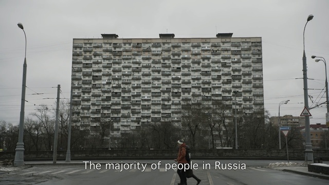 Video Reference: Wall, Architecture, Facade, Asphalt, Residential area, Tree, Urban design, Street, Building, City, Person