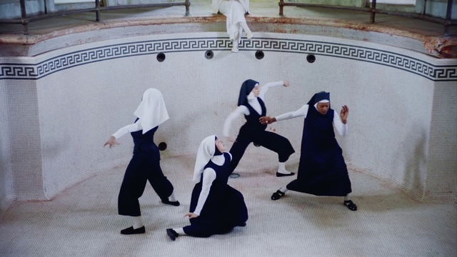 Video Reference: Aikido, Dance, Sport venue, Person, Building, Small, Man, Stuffed, Table, Bear, Display, Young, Group, People, Holding, Woman, Standing, White, Ball, Room, Boat, Playing, Floor, Clothing