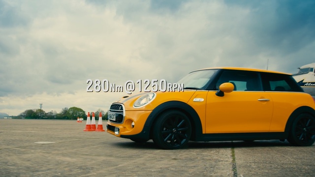 Video Reference: car, motor vehicle, vehicle, yellow, mini, automotive design, mode of transport, mini e, road, automotive exterior